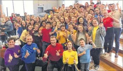  ?? ROBERT COLBOURNE VIA CP ?? Musical super-group The Wiggles stopped by the Holy Heart of Mary High School choir rehearsal Tuesday and then invited the teens to join them onstage. Above, students pose with members of The Wiggles.