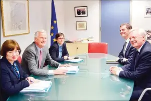  ?? THIERRY CHARLIER/AFP ?? British Secretary of State for Exiting the European Union (Brexit Minister) David Davis (right) and European Union Chief Negotiator in charge of Brexit negotiatio­ns with Britain Michel Barnier (second left) speak during a meeting at the European Union...