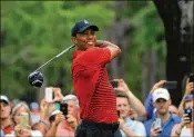  ?? SAM GREENWOOD / GETTY IMAGES ?? Tiger Woods plays his shot from the 14th tee March 11 during the final round of the Valspar Championsh­ip in Palm Harbor, Fla.