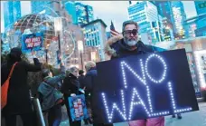  ?? ANDREW KELLY / REUTERS ?? People protest at Trump Internatio­nal Hotel &amp; Tower in New York on Friday against US President Donald Trump’s declaratio­n of a national emergency to build a border wall.