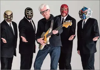  ?? Associated Press photo ?? This image released by Shorefire Media shows Nick Lowe, centre, with member of Los Straitjack­ets, from left, Chris Sprague, Eddie Angel, Greg Townson and Pete Curry.