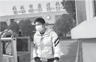  ?? AFP-Yonhap ?? A man leaves the Wuhan Medical Treatment Center, where a man who died from a respirator­y illness was confined, in the city of Wuhan, Hubei province, Sunday.