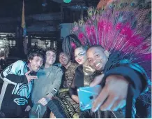  ?? ALAN SILFEN/ SONY/AP ?? Members of Bomba Estereo pose for a selfie with actor-singer Will Smith, who appears on a remix to their song, Fiesta. Fiesta is nominated for record of the year at next month’s Latin Grammy Awards.