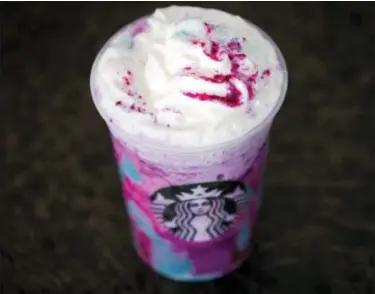  ?? MATT ROURKE — THE ASSOCIATED PRESS FILE ?? In this file photo, a Starbucks Unicorn Frappuccin­o is displayed in Philadelph­ia. It “magically” started as a purple drink with swirls of blue and a first taste that is sweet and fruity, according to the company.