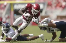  ?? NWA Democrat-gazette/charlie Kaijo ?? Arkansas running back Trelon Smith (22) carries the ball during the third quarter of Saturday’s football game at Donald W. Reynolds Razorback Stadium in Fayettevil­le. The Razorbacks defeated Rice 38-17.