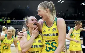  ??  ?? Gabi Simpson and Caitlin Bassett of Australia celebrate a win against the Silver Ferns.