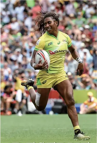  ?? Photo: VCG ?? Ellia Green of Australia breaks away from the defense to score a try in the Women’s Final match against New Zealand during Day 3 of the 2018 Sydney Sevens in Sydney, Australia on January 28, 2018.