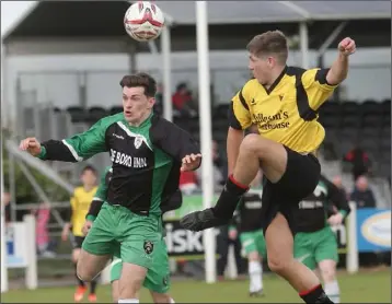  ??  ?? Cloughbawn’s Gavin Murphy gets his head to the ball ahead of Mark Mythen of Bridge Rovers.