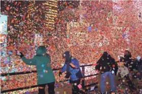  ??  ?? A blizzard of confetti is dispersed at a New Year’s Eve celebratio­n in New York’s Times Square.