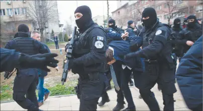  ?? AP PHOTO ?? Kosovo police escort Marko Djuric a Serb official to a police station in Kosovo capital Pristina after he was arrested in northern Kosovo town of Mitrovica on Monday. Kosovo police arrested a Serb official after he was banned from visiting a divided...
