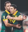  ??  ?? Cameron Smith and Billy Slater celebrate a World Cup try.