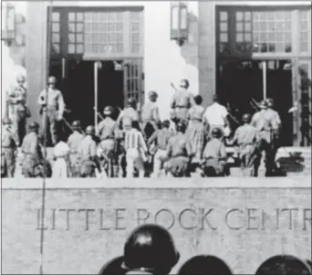  ?? FILE — THE ASSOCIATED PRESS ?? In this file photo, nine African American students enter Ark., escorted by troops of the 101st Airborne Division. Central High School in Little Rock,