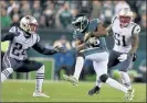  ?? NANCY LANE / HERALD STAFF FILE ?? Former Eagles wideout Nelson Agholor, who will play in Foxboro next season, hauls in a catch between cornerback Stephon Gilmore, left, and linebacker Ja’Whaun Bentley on Nov. 17, 2019.