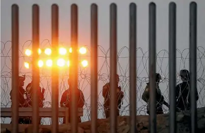  ?? GETTY IMAGES ?? US Border Patrol agents stand watch at the USMexico border fence in Tijuana yesterday.