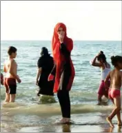  ?? RYAD KRAMDI/AFP ?? A woman wears a burkini on a beach in Algeria’s capital Algiers on August 3.