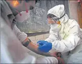  ?? SANCHIT KHANNA/HT ?? A health worker collects a blood sample during Delhi’s first sero n survey in early July.