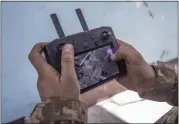  ?? AP ?? A Ukrainian soldier looks at a drone screen showing Russian troops positions during heavy fighting at the front line in Severodone­tsk, Luhansk region, Ukraine, Wednesday.