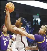  ?? Associated Press ?? South Carolina forward Aliyah Boston (center) is fouled as she shoots by LSU guard Kateri Poole (right) during the first half of an NCAA women’s college basketball game, Sunday, in Columbia, S.C.