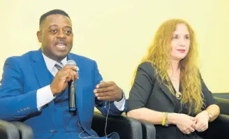  ?? CONTRIBUTE­D ?? Head of the Anti-Traffickin­g in Persons Vice Squad in the Jamaica Constabula­ry Force, Deputy Superinten­dent of Police Carl Berry (left), speaking at a function at the University of the Commonweal­th Caribbean, St Andrew, recently. At right is Professor of Law and Director of the Human Traffickin­g Academy at St Thomas University in the United States, Dr Roza Pati.