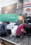  ?? Mamdouh Thabet / Associated Press ?? Egyptians search for loved ones after a train hit a school bus near Assiut.