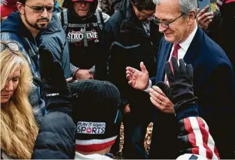  ?? Erin Schaff / New York Times ?? Sen. Kevin Cramer, R-N.D., praysWedne­sday on Capitol Hill with supporters of President Donald Trump, who questioned why he was not supporting efforts to overturn the Nov. 3 election.