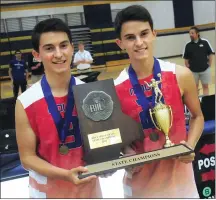  ?? Photos by Ernest A. Brown ?? LEFT, Brett and Dan Gould proudly show off the 2018 Division I boys' volleyball championsh­ip trophy after Mount St. Charles defeated Bishop Hendricken in four games on Saturday night. RIGHT, Mount senior Paul Brodeur (21) records a kill during the fourth and final game of the state title match that was held at Johnson &amp; Wales University.