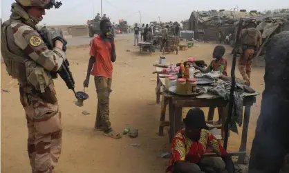  ?? Daphne Benoit/AFP/Getty Images ?? A French soldier in Gossi, Mali. Paris is winding down its almost decade-long military operation in the west African country. Photograph: