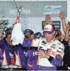  ?? ASSOCIATED PRESS ?? Denny Hamlin celebrates winning the Daytona 500 on Sunday at Daytona Internatio­nal Speedway. JASEN VINLOVE/USA TODAY
