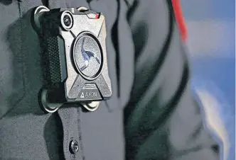  ?? GAVIN YOUNG • POSTMEDIA ?? A Calgary Police officer wears one of the service’s Axon body cameras in a July 2018 file photo.