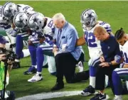  ?? THE ASSSOCIATD PRESS ?? The Dallas Cowboys, led by owner Jerry Jones, center, take a knee prior to the national anthem Sunday prior to playing the Arizona Cardinals in Glendale, Ariz.