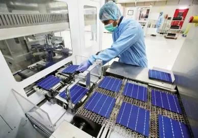  ??  ?? An employee works at a solar cell production line at Jupiter Solar Power Ltd. (JSPL) plant in Baddi, in the northern state of Himachal Pradesh, India in this file photo. (Reuters)