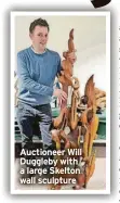  ?? ?? Auctioneer Will Duggleby with a large Skelton wall sculpture