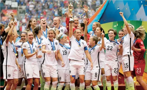  ??  ?? The United States Women’s National Team celebrates with the trophy after they beat Japan in the FIFA Women’s World Cup soccer championsh­ip in Canada. FIFA has made a point of proclaimin­g that it aims to raise both the role of women in the organizati­on...