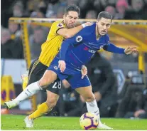  ?? Picture: GEOFF CADDICK/AFP ?? BALL BATTLE: Wolverhamp­ton Wanderers' Joao Moutinho tries to round Chelsea's Eden Hazard during their English Premier League football match.