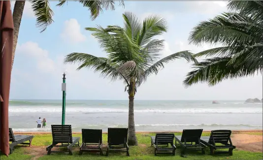  ?? ERANGA JAYAWARDEN­A/AP PHOTO ?? Lounge chairs lie on a deserted beach in Hikkaduwa, Sri Lanka, on May 10. Sri Lanka was the Lonely Planet guide’s top travel destinatio­n for 2019, but since the Easter Sunday attacks on churches and luxury hotels, foreign tourists have fled.