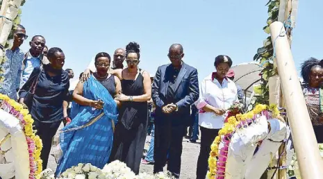  ?? AFP ?? Families of victims from Kenya and Rwanda lay flowers on Sunday, as they visit the crash site of the Ethiopian Airlinesop­erated Boeing 737 MAX aircraft which killed 157 passengers and crew onboard, at Hama Quntushele village in Oromia region.