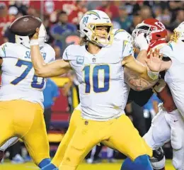  ?? ED ZURGA AP ?? Justin Herbert sustained fractured rib cartilage in the Chargers’ loss to the Chiefs last week. He is listed as questionab­le; he says pain is part of the game.