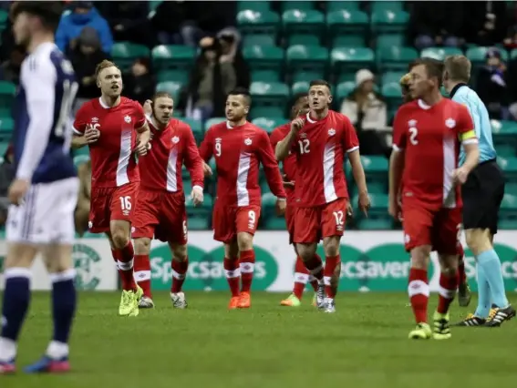  ??  ?? Canada's players celebrate their shock opening goal (Getty)