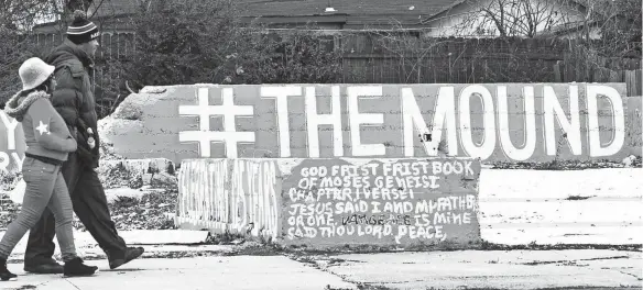  ??  ?? A couple passes a mural in Orange Mound on Park Avenue in 2016. Despite Orange Mound’s roots of being built on a plantation, it became the first urban community in America built by and for African Americans. YALONDA M. JAMES / FILE / THE COMMERCIAL APPEAL