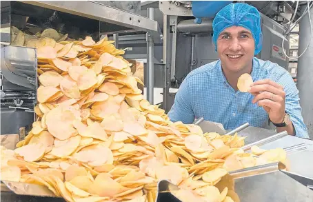  ?? Picture: Angus Findlay. ?? James Taylor, commercial director at Mackie’s, with some of the company’s strawberry crisps at its Perthshire factory. The flavour may make its way to the UK at some point.