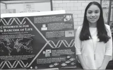  ?? Photos by Erica Moser ?? Left: Central Falls High School student Stephanie Aldana shows off a project on DNA.