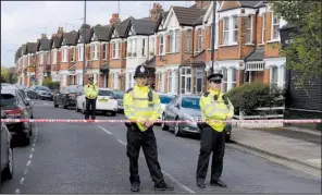  ?? AP/PA/STEFAN ROUSSEAU ?? Police officers guard a cordoned-off area in London on Friday, a day after a counterter­rorism raid that left a woman wounded.