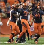  ?? ADRIAN KRAUS - THE ASSOCIATED PRESS ?? Syracuse defensive lineman Alton Robinson (94) celebrates a defensive fumble recovery during the first half of an NCAA college football game against Louisville in Syracuse, N.Y., Friday, Nov. 9, 2018.