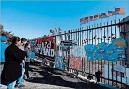  ?? NICK UT/AP ?? People pay their respects Friday at a makeshift memorial in San Bernardino, Calif.