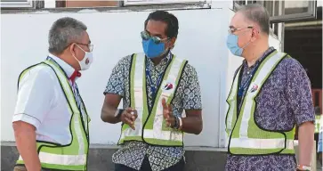  ??  ?? Close coordinati­on: Dr Adham (left) speaking with Khairy (centre) and Dr Wee at Kuala Lumpur Internatio­nal Airport. — Bernama