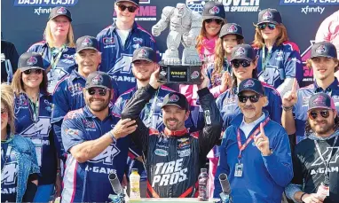  ?? JASON MINTO/ASSOCIATED PRESS ?? Josh Berry holds up the trophy in victory lane after winning the NASCAR Xfinity Series auto race Saturday at Dover Motor Speedway in Dover, Del.