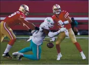  ?? NHAT V. MEYER — BAY AREA NEWS GROUP ?? The Dolphins’ Emmanuel Ogbah knocks the ball out of 49ers quarterbac­k C.J. Beathard’s (3) hands for a turnover at Levi’s Stadium in Santa Clara on Sunday.