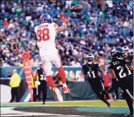  ?? Matt Rourke / Associated Press ?? Giants tight end Evan Engram catches a touchdown during the second half against the Eagles on Sunday in Philadelph­ia.