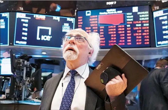  ??  ?? In this file photo, trader Peter Tuchman works on the floor of the New York Stock Exchange. The 2020 presidenti­al election is clearly unlike any other, but investors might be wise to treat it just like most of the previous ones. History shows the stock market’s performanc­e doesn’t correlate that closely with which party controls the White House: It tends to rise following elections regard
less of who wins. (AP)