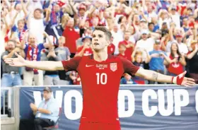  ?? Matthew Stockman / Getty Images ?? Christian Pulisic, an 18-year-old from Pennsylvan­ia, scored both goals as the United States shut out Trinidad and Tobago 2-0 in World Cup qualifying.